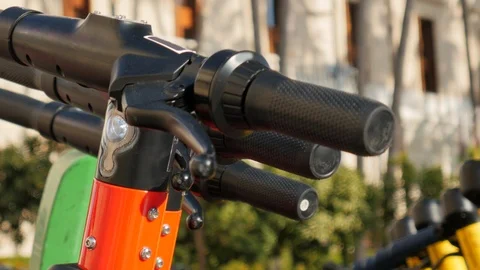 4k static close up shot selective focus of handle bars of shared scooters Stock Footage 123411984