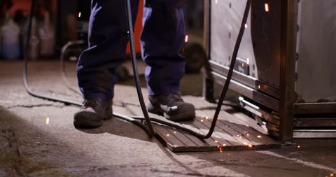 4K Static floor level shot of welder working &amp; sparks falling to the floor Stock Footage 103833389