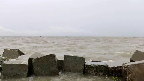4K Static River Waves Hitting Concrete Breakwater Under Cloudy Sky Stock Footage 338401665