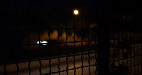 4K STATIC SHOT HIGHWAY THROUGH A FENCE AT NIGHT Stock Footage 131279904