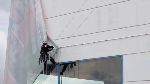 4k static shot of industrial climber or rope access technician working Stock Footage 123369657