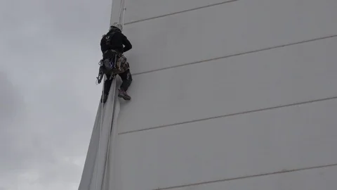 4k static shot of industrial climber or rope access technician working at height Stock Footage 123405341