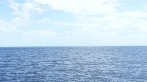 4K static shot of open ocean horizon with ripples and cloudy blue sky 스톡 동영상 337088601