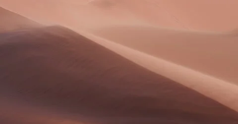 4K static shot of sand blowing over the sand dunes in Namibia Stock Footage 64697148