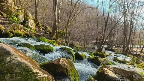 4K Static Spring Flow - Pure Water Over Mossy Rocks Nature Background Video stock 332374557