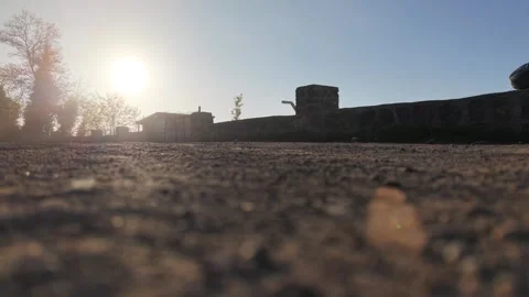 4K Static Sunset Shot as Motorcycle Emerges from Golden Sunlight Stock-Footage 339295360