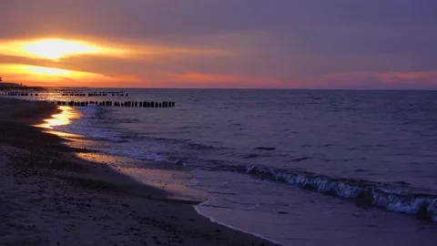 4k static video of a dramatic golden sunset over a calm sea with a 1-minute l Stock Footage 347028385