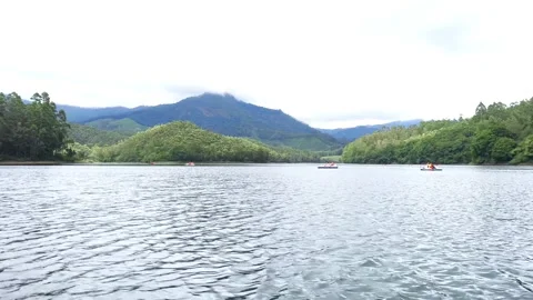 4K Static Video of People Boating on Mountain Lake at Kundala Dam Munnar Stock Footage 340067577
