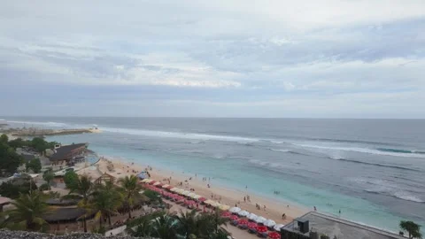 4K Static View of Melasti Beach – Relaxed Vibes with Umbrellas and Ocean Waves Stock Footage 312509351