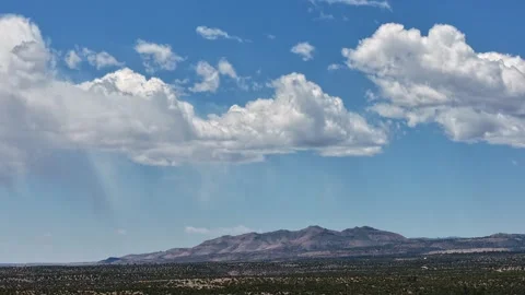 4K Steady Timelapse of Lightly Raining Clouds Over a Southwest Desert Mountain Stock Footage 335921095