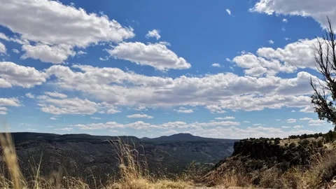 4K Steady Timelapse of Swift Clouds Over a Desert Canyon Mountain with Golden Stock Footage 335921124