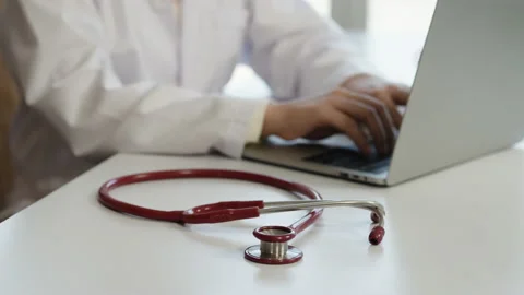 4k, stethoscope close-up of a doctor lying on desk with a blurry background Stock Footage 169986297