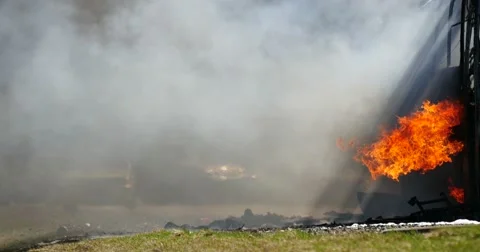 4K Stock Footage Exploded Bus Burns on the Higway Video stock 55857241