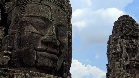 4K, Stone faces statue of Bayon temple. Angkor Thom is a tourist attraction.-Dan Stock Footage 119057520