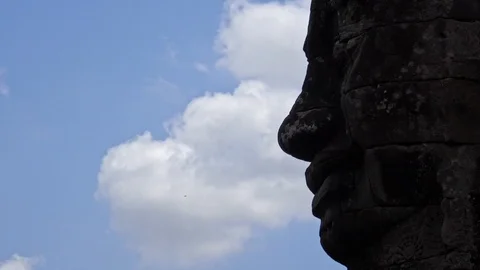 4K, Stone faces statue of Bayon temple. Angkor Thom is a tourist attraction.-Dan Stock Footage 119057590