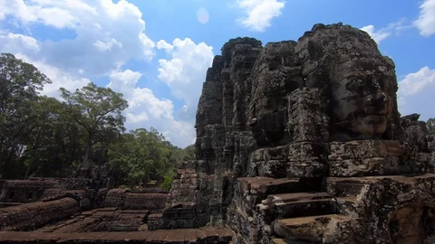4K, Stone faces statue of Bayon temple. Angkor Thom is a tourist attraction.-Dan Stock Footage 119057658