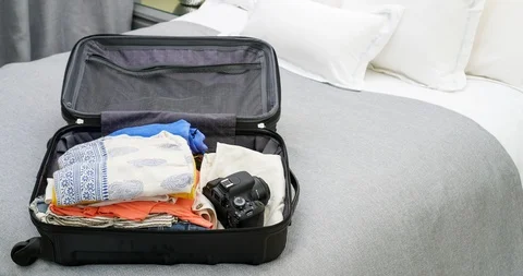 4K Stop Motion Animation Of Empty Suitcase Being Filled Up With Women's Clothes Stock Footage 86404916