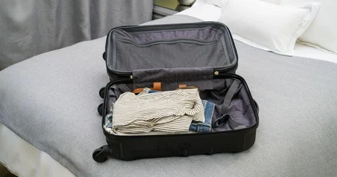 4K Stop Motion Animation Of Empty Suitcase Being Filled Up With Women's Clothes Stock Footage 86405394