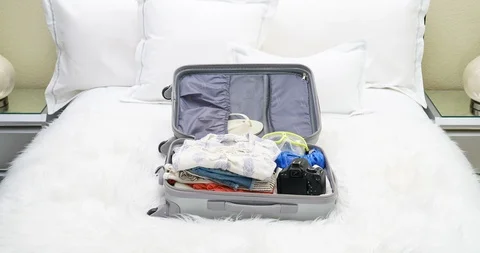 4K Stop Motion Animation Of Empty Suitcase Being Filled Up With Women's Clothes Video stock 86448937