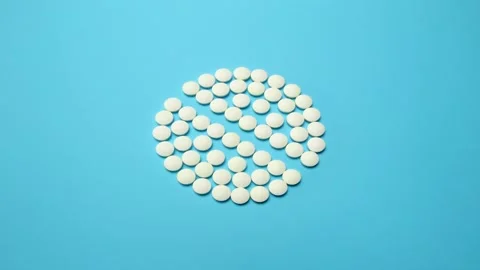 4K Stop motion animation loop of white pill on blue background Stock Footage 157237240