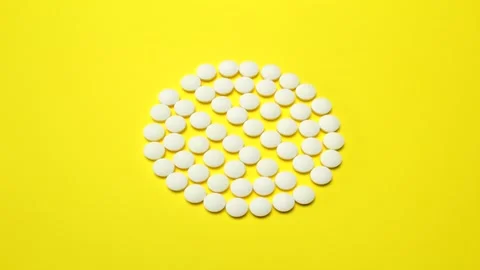 4K Stop motion animation loop of white pill on  yellow background Stock Footage 160291394