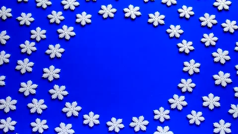 4K Stop motion animation loop of white snowflake on blue background Stock Footage 166703273