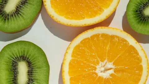 4K Stop motion of dancing orange and kiwi on white background. Stock Footage 117037031