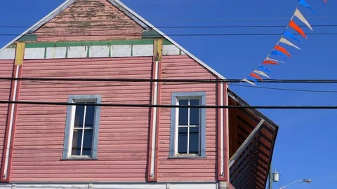 4K Store Front Wooden Old Building and Flags Slow Motion Stock Footage