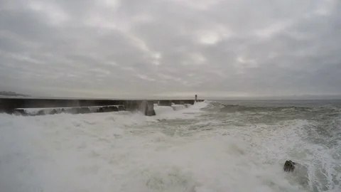 4K. Storm and lighthouse in the ocean. Huge waves cover everything. Portugal. Video stock 74171685