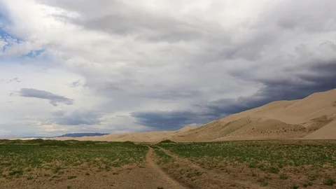 4K. Storm clouds before rain in the Gobi Desert, dune Hongoryn, Mongolia. Ult Stock Footage 77071043
