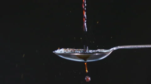 4K A Stream of balsamic vinegar being poured onto spoon against Stock Footage 55854993