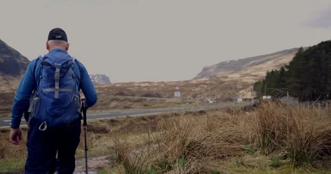4K Student Trekkers at The Glen Coe Scottish Mountains. Tourist Travelling. Stock Footage 93063759