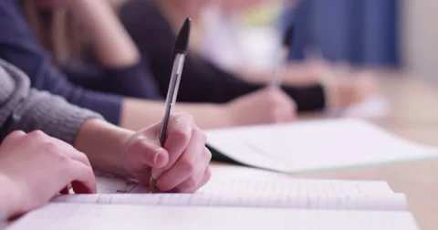 4k, Students in school uniform taking exam at desk in a classroom. Slow motion. Видео