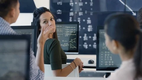 4K Students working on computers &amp; chatting in adult education math class Stock Footage 73178362