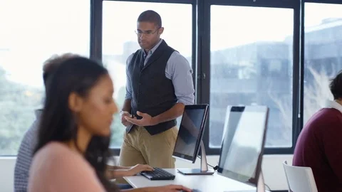 4K Students working on computers &amp; teacher giving help in adult education class. Stock Footage 73172761