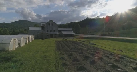 4K Stunning Farm with Fields in foreground and Mountain Sunset. Stock Footage
