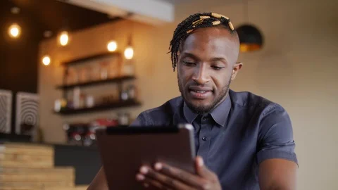 4k stylish young man using tablet in the trendy coffee shop. Stock Footage 111333263