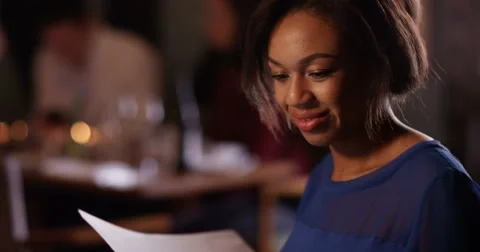 4K Successful young bar owner smiles to herself as she looks over the figures Stock Footage 62914193