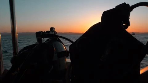 4K sun setting over the red sea behind scuba dive gear, Egypt Stock Footage 252350622