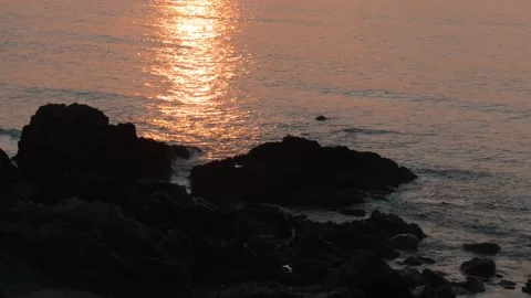 4K sun setting over the sea along the rocky Welsh coastline 動画素材 233120370