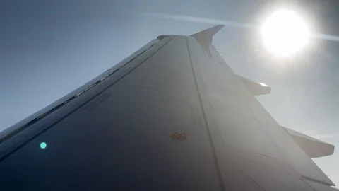 4K, Sun shine as seen through airplane window during takeoff. Traveling air.-Dan Stock Footage 124673988