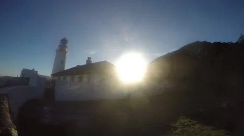 4k Sun shining over lighthouse with blue sky behind Stock Footage 46533603