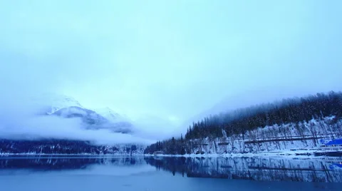 4K. Sunset on an alpine lake Ritsa winter under gloomy clouds, Abkhazia,  Stock Footage 59740958