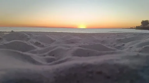 4K Sunset Beach Shot with Sand Dunes in Foregrond - Calm Ocean - golden Hour 16s Stock Footage 321262685