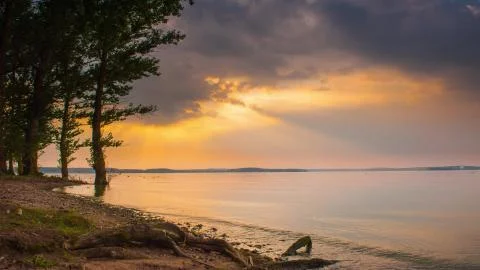 4K sunset beautiful summer landscape with cloudy sky and natural lake Stock Photos