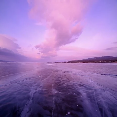 4K. Sunset in the icy Lake Baikal in the red colors, Irkutsk region, Russia. Stock Footage