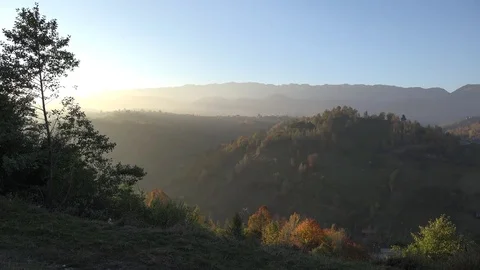 4K Sunset light bright at mountain hill forest landscape by day misty sunrise Stock Footage 80072928