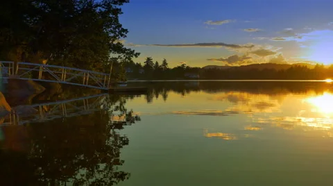 4K Sunset Light Reflects on Mirror-Like Lake Water Surface, Calm Water Stock Footage 68446504