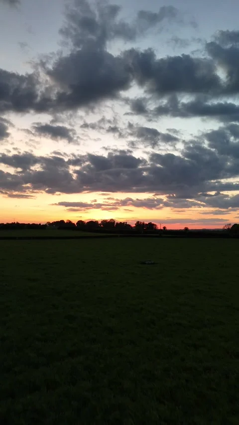 4K Sunset Over Rural Field with Dramatic Clouds Stock Footage 333929502