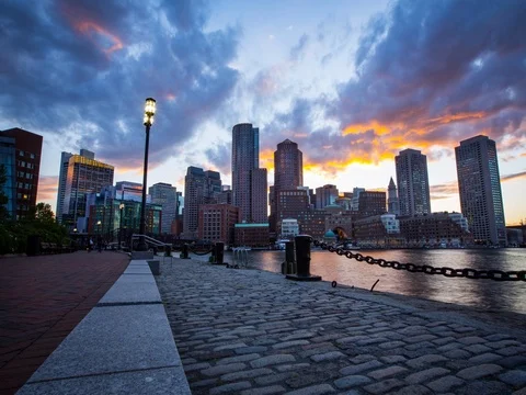 4K Sunset Time Lapse of Boston Skyline Over Harbor Vídeo Stock 76314042